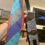 A sheathed kung-fu practice sword, with neckties tied to the hilt and googly eyes pasted all over the scabbard